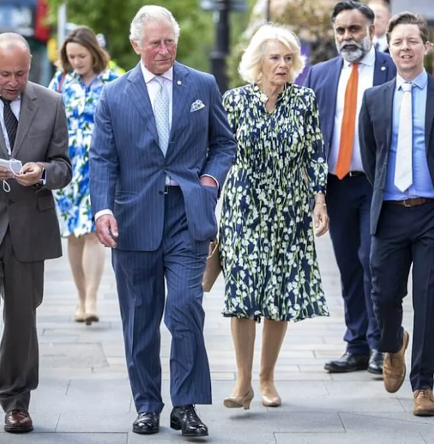 The Duchess of Cornwall wore a floral print silk dress by designer, Fiona Clare. Camilla carried for her Bottega Veneta bag