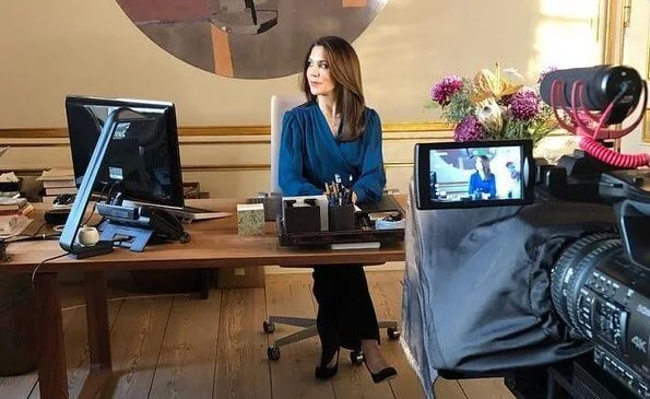 The Ministry of Education. Crown Princess Mary wore a dark blue self-tie wrap silk long sleeve blouse long sleeve top from Michael Kors