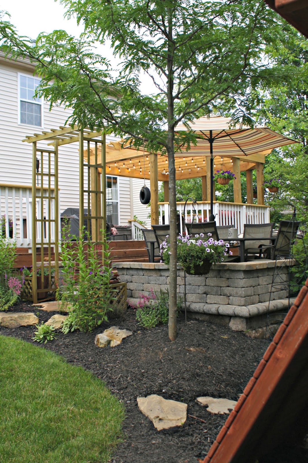 Pergola, deck and paver patio with landscaping