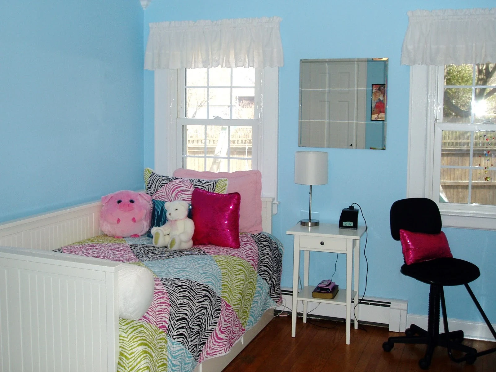 Blue bedroom with rainbow zebra quilt