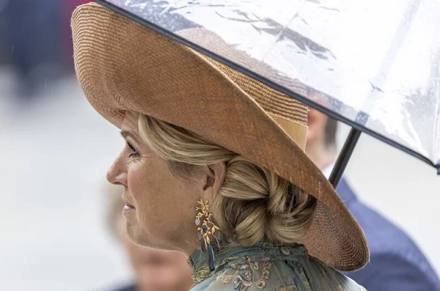 Queen Maxima wore a floral print dress from spring summer 2020 collection of Natan. Gold diamond earrings from Ole Lynggaard