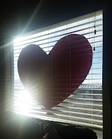 Valentine heart in window. Remembering love early in the day.