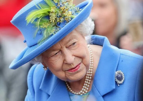 Queen Elizabeth opened the new housing development of Haig Housing. Pearl earring and pearl necklace, diamond brooch