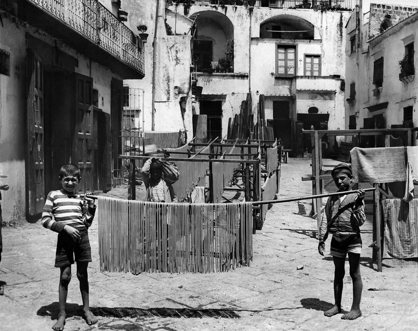 Italian boys showing drying pasta. 1928.
