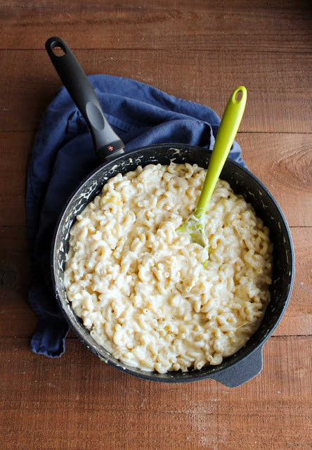 This is the creamiest stovetop macaroni and cheese recipe ever! It is good on it's own or stir in some ham for a simple family pleasing dinner. pot filled with creamy stovetop mac and cheese