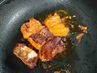 Crisp golden charred fish tikka on tawa or pan