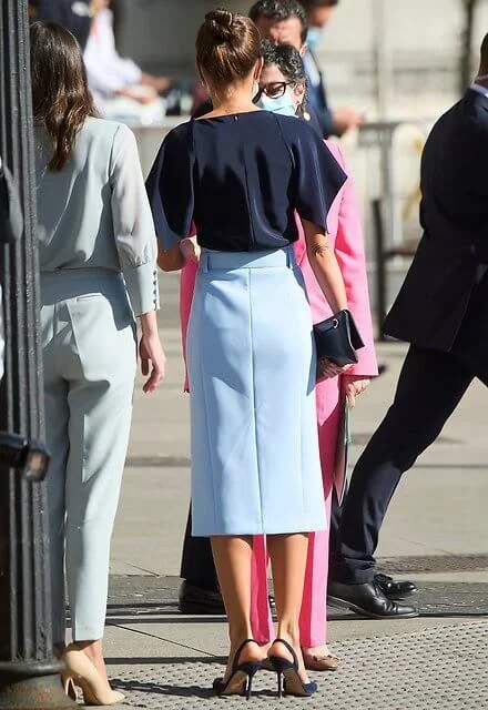 Queen Letizia wore a v-neck pure silk flared sleeves navy blue top and a sky-blue high waisted pencil skirt from Hugo Boss