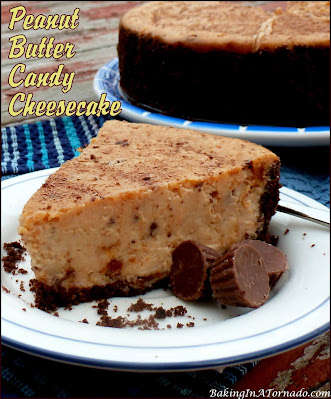 Peanut Butter Candy Cheesecake, a creamy Reese’s cheesecake, studded with chopped Butterfingers and topped with a shaved chocolate bar. | recipe developed by www.BakingInATornado.com | #recipe #dessert