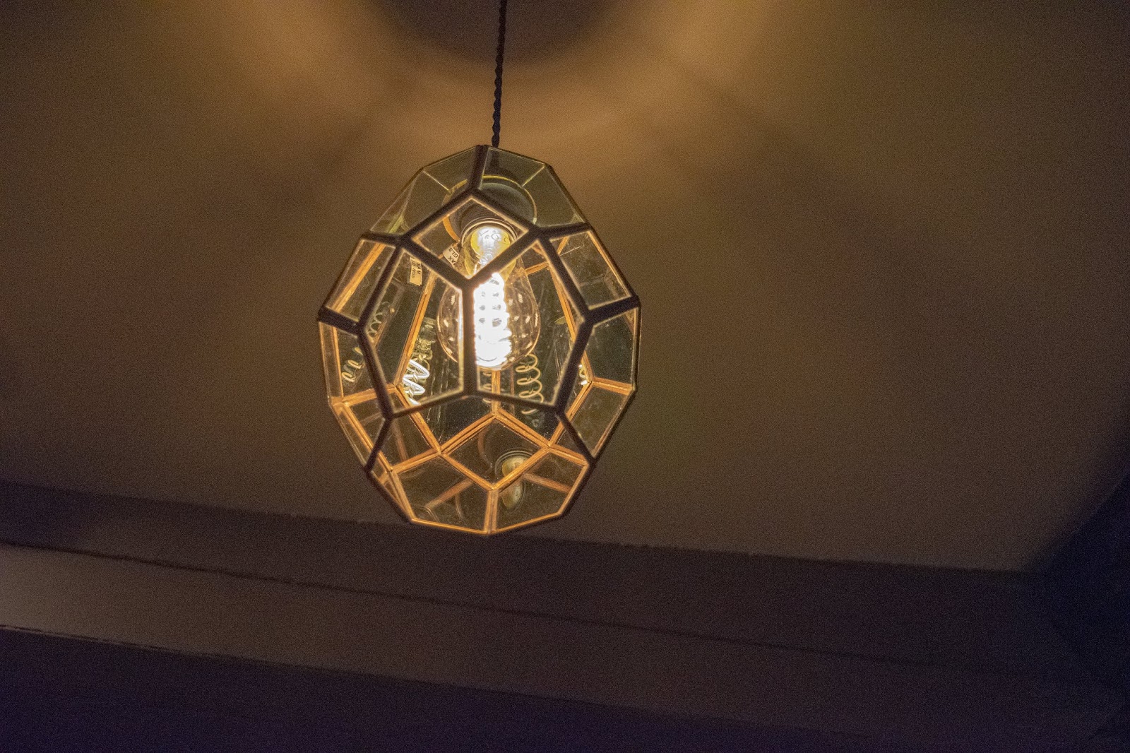 A gold geometric light fitting at The Red Lion