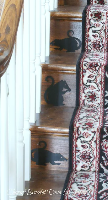 three rat silhouettes on stairs