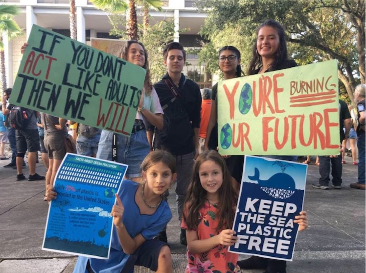 (left to right in back) Champakalata, Shyam, Nadia, Vrindavani, and (front) Raseshvari and Liliana protest at City Hall in Gainesville