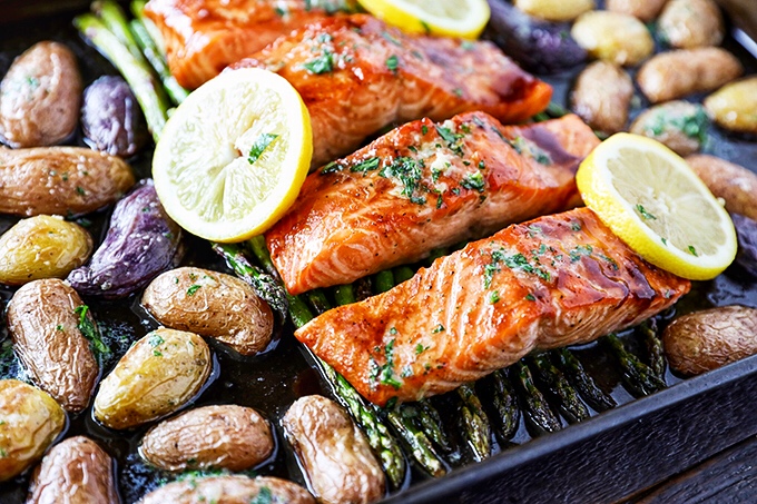 This Sheet Pan Salmon Dinner recipe is so easy to make and absolutely loaded with flavor! Glazed salmon with garlicky roasted potatoes and asparagus, and everything cooks on the same pan
