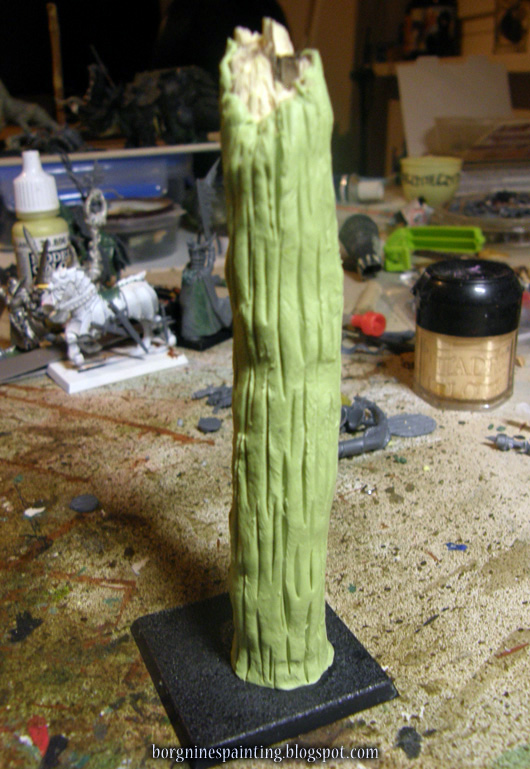 The greenstuff-milliput mix around the stick has now numerous vertical indentations all around its surface.