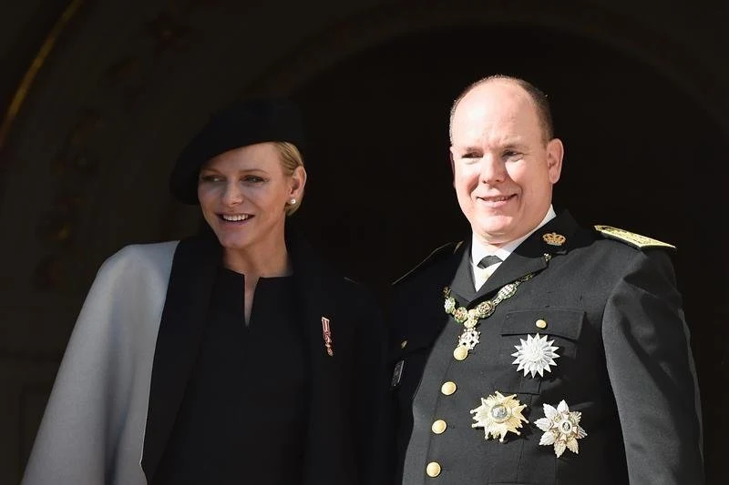 Princess Charlene of Monaco kisses Prince Albert II of Monaco on the balcony of Monaco Palace during celebrations marking Monaco's National Day in Monaco