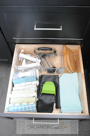 Organized linens in deep drawer in kitchen cabinets :: OrganizingMadeFun.com