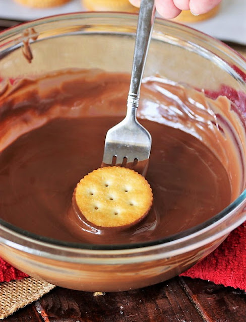 Dipping Peanut Butter Ritz Cracker Sandwiches in Chocolate Image