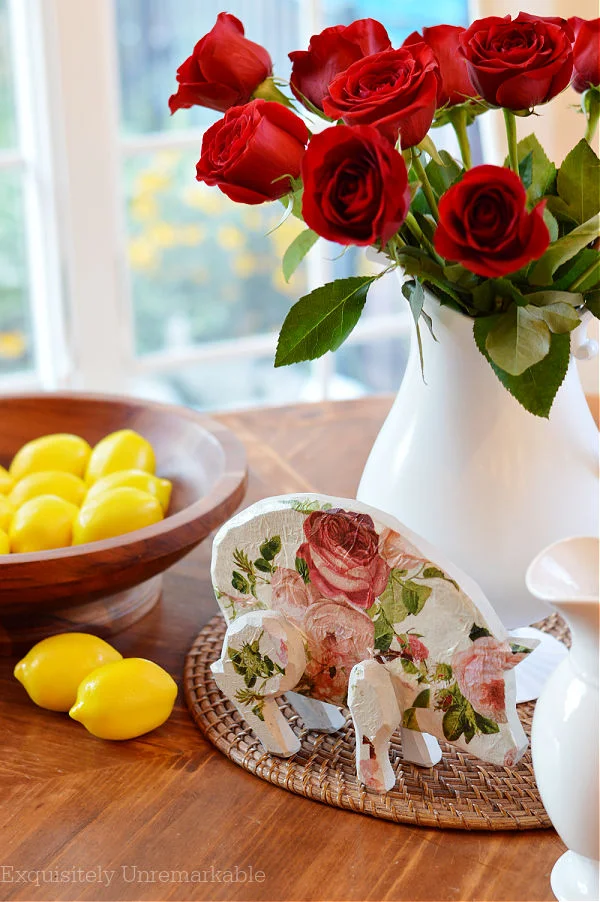 Cottage Style Wooden Pig on a table with lemons and roses