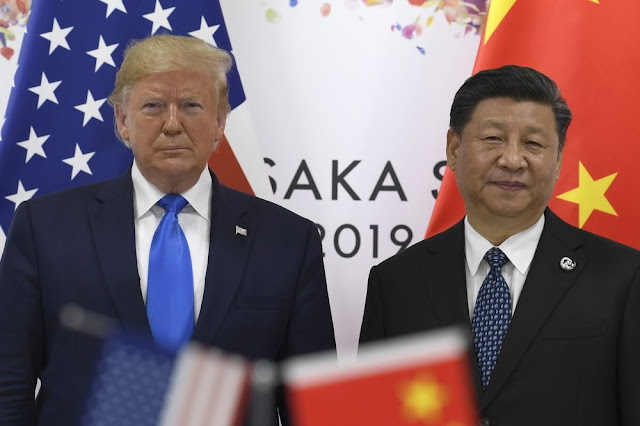 Image Attribute: U.S. President Donald Trump, left, poses for a photo with Chinese President Xi Jinping during a meeting on the sidelines of the G-20 summit in Osaka on June 29, 2019. Photographer: Susan Walsh/AP