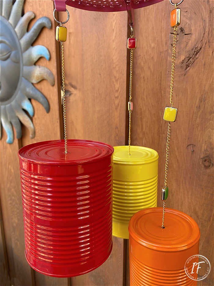 How to make bright and whimsical Upcycled Tin Can Wind Chimes with recycled food cans, a vintage strainer, and old necklace for unique garden decor.