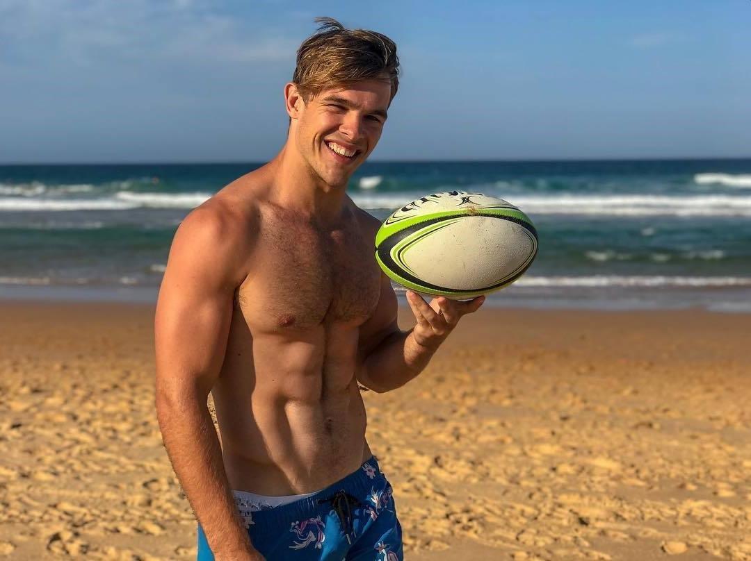 cute-blond-hairy-barechest-twink-smiling-beach