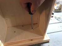 Permanently securing the drawer body to the drawer front 