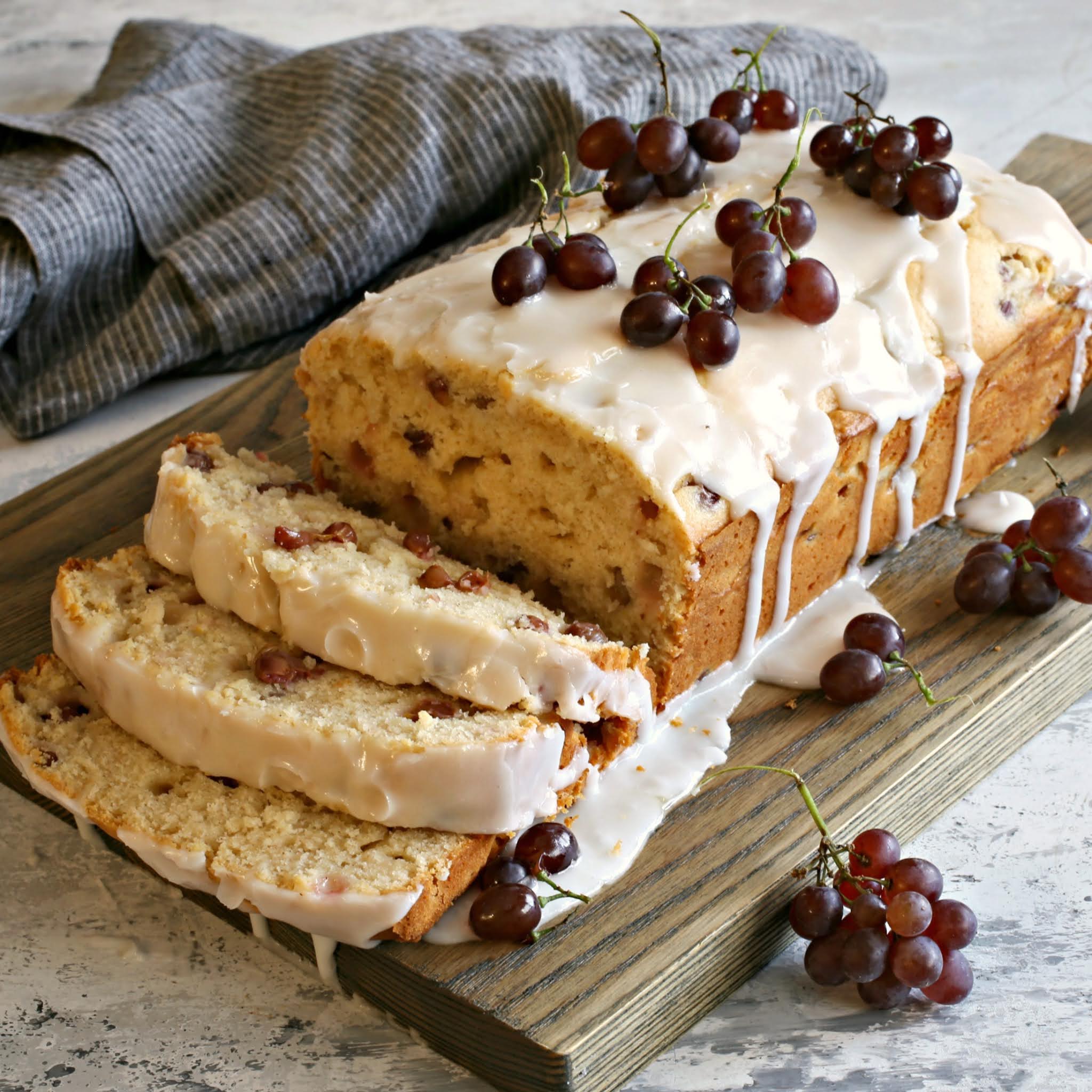 Recipe for a loaf cake baked with champagne grapes and topped with a lemon glaze.