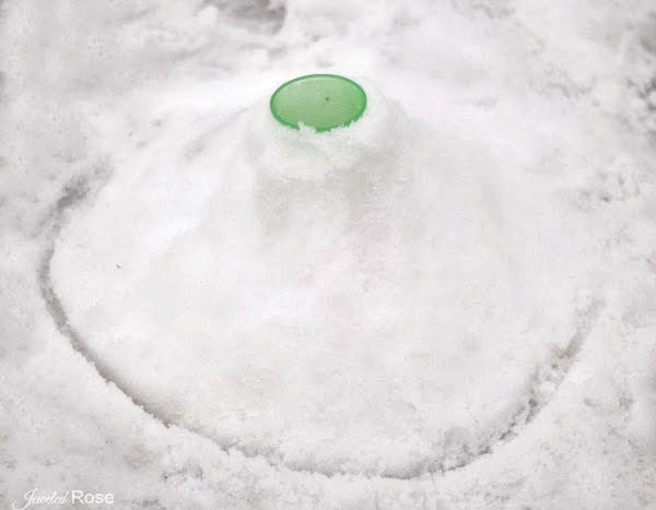 Take winter play to the next level and make a snow volcano!  This experiment is great for preschool and elementary. #snow #snowcrafts #snowactivitiesforpreschool #snowexperimentsforkids #snowvolcano #snowvolcanoforkids #snowvolcanohowtomake #snowvolcanoexperiment #volcanoprojectforkids #volcanoexperiment #winterscienceexperimentforkids #growingajeweledrose #activitiesforkids