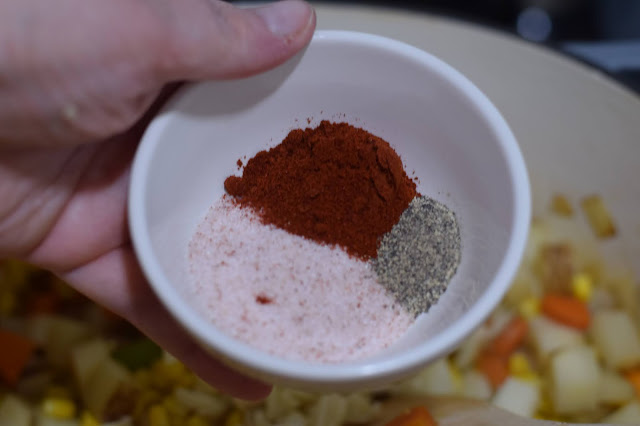 The spices being added into the chowder.