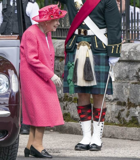The Queen wore a raspberry pink coat and a matching hat, with a floral dress