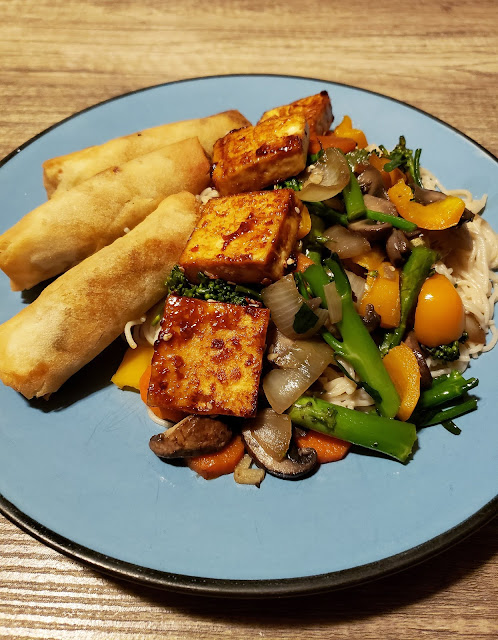 Stir fry, ramen noodles, fried tofu, and veggie spring rolls