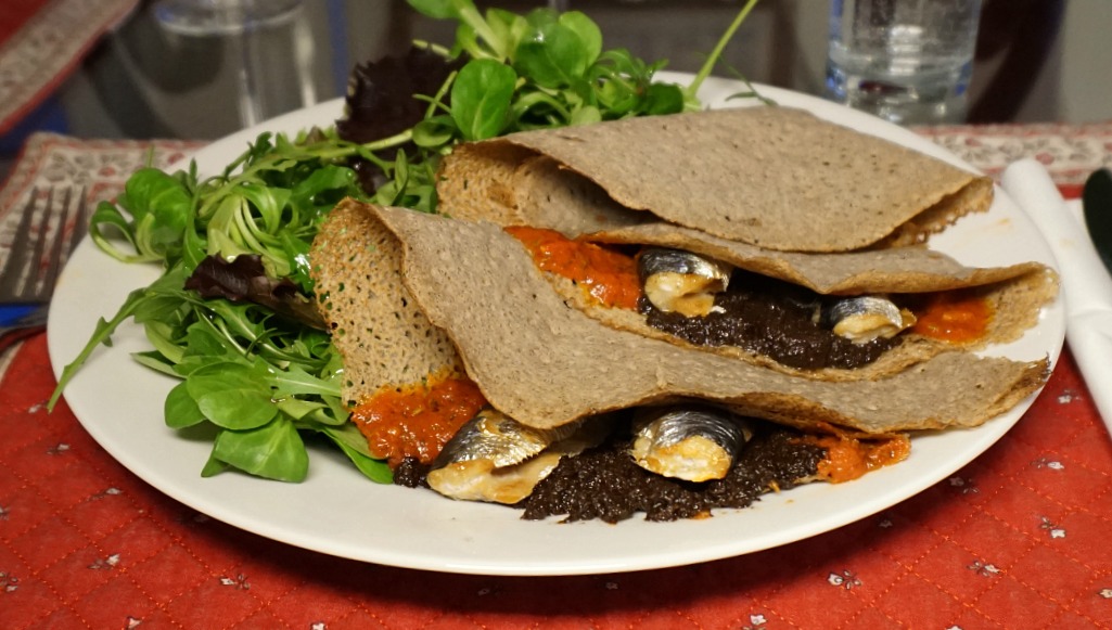 Buckwheat pancakes with sardine fillets savoury tomato sauce and tapenade