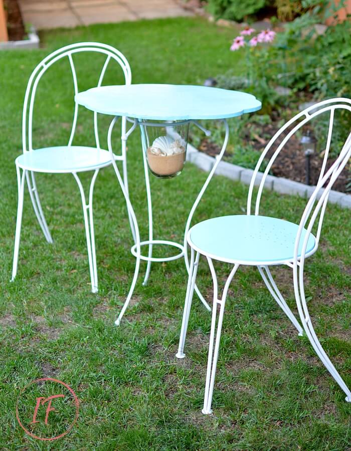 How to turn a hurricane candle holder with metal base and thrift store cafe chairs into a unique one-of-a-kind Coastal Bistro Dining Set for summer.