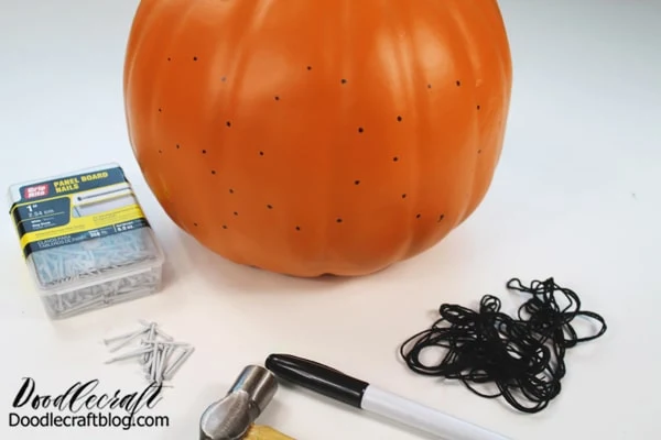 Step 1: Dot the Pattern Begin by using the marker on the pumpkin to dot out where you want nails placed. I simply wrote out the word "BOO", so the dots were easy to place.