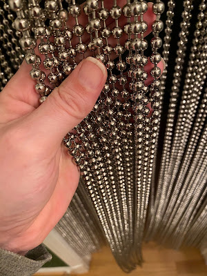 Close up photo of my hand holding some of the beads.