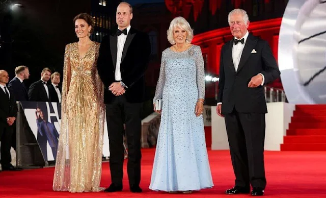 Kate Middleton wore a shimmering cape gown by Jenny Packham. Gold earrings. Aquazzura Fenix gold metallic leather pumps