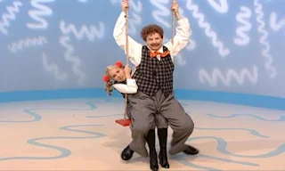 Mrs. Noodle gets on the swing. Mr. Noodle sits on Mrs. Noodle's lap. it's not taking turns. Sesame Street Elmo's World Friends The Noodle Family