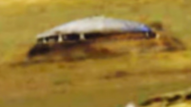 Mars Flying Saucer is parked on the side of a cliff.