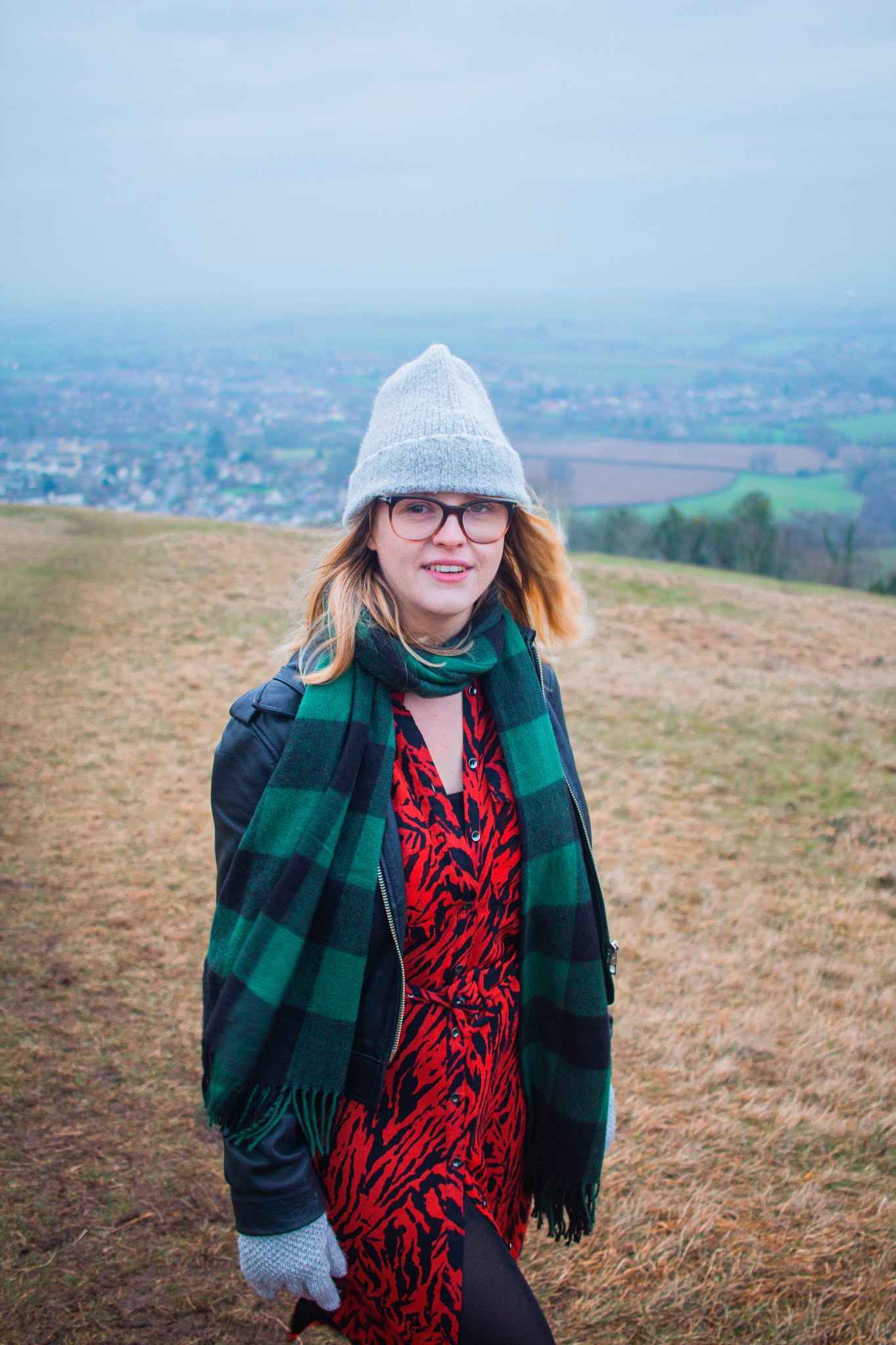 chloe harriets on walk in nature, scenic view, wearing mint velvet dress, whistle leatther jacket and beanie. 2020 bucket list