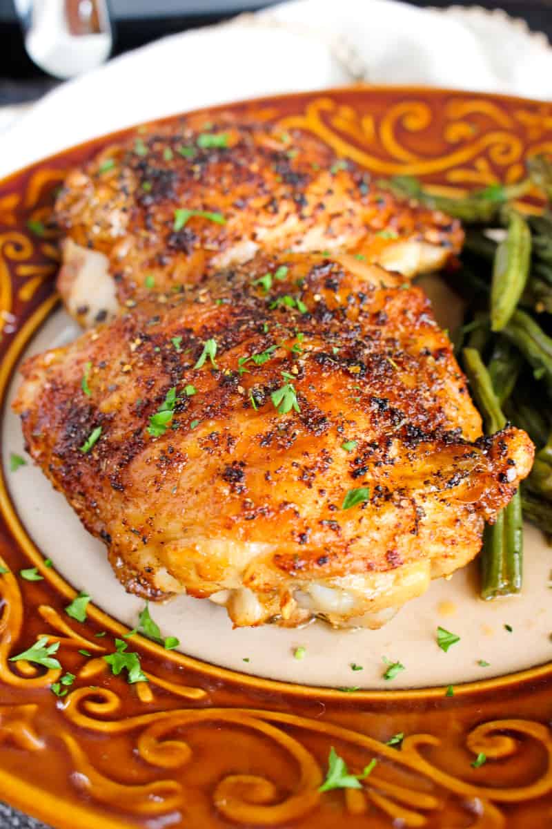 The Best Air Fryer Chicken Thighs are super juicy inside with extra crispy seasoned skin. Once you try them, you will never want to cook them any other way! #airfryer #chicken
