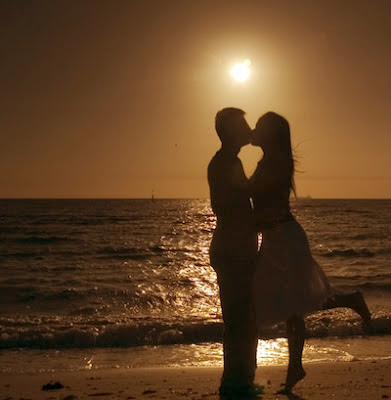 kissing on the beach sunset
