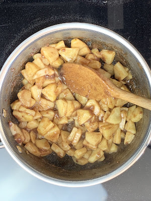 Chopped apples and spices cooking  in a saucepan