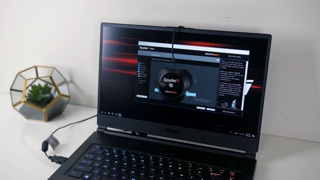 The 15.6-inch FHD display of MSI GS65 Stealth laptop is being tested using Spyder 5 PRO for color accuracy.