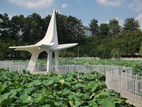 curving bridge, sculpture, and lotuses at Bajiao Pond (八角塘)
