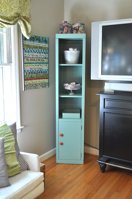 Tall skinny storage in this fun craft room! craft room cabinet