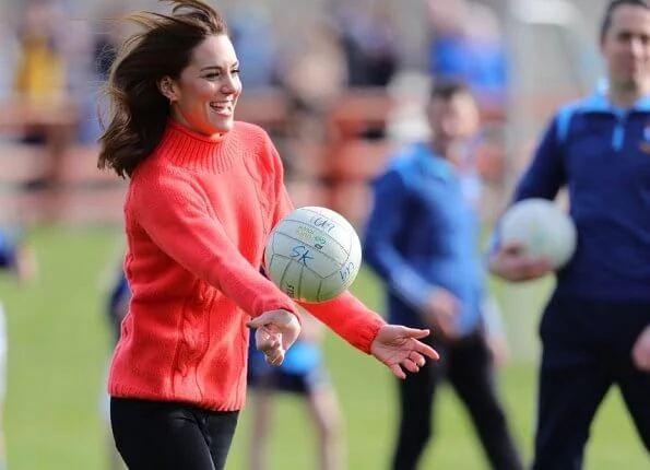 Kate Middleton wore a green midi dress by Suzannah. Alexander McQueen khaki long coat and Jimmy Choo boots