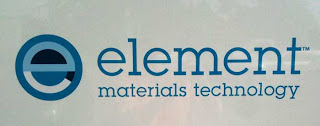 Element Materials Technology logo, blue black and white lower case e in a circle
