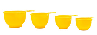 measuring cups in a fun color or design, like these bright yellow cups, make for a fun, easy gift