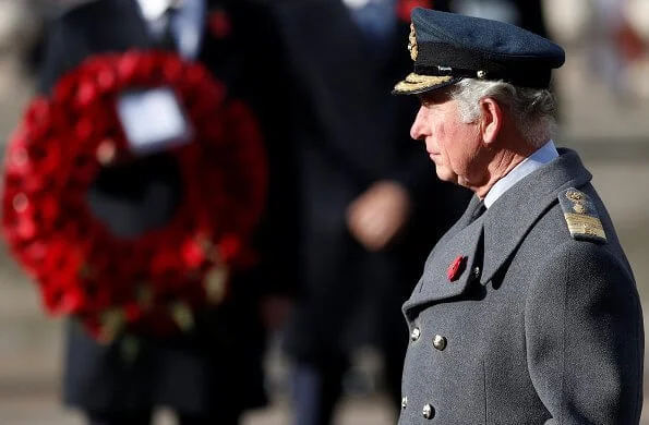 Kate Middleton wore a bespoke black military coat by Alexander McQueen, and a Philip Treacy hat. Queen's diamond and pearl earrings