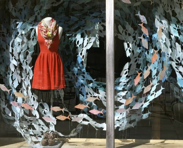 store window display of swirling paper school of fish