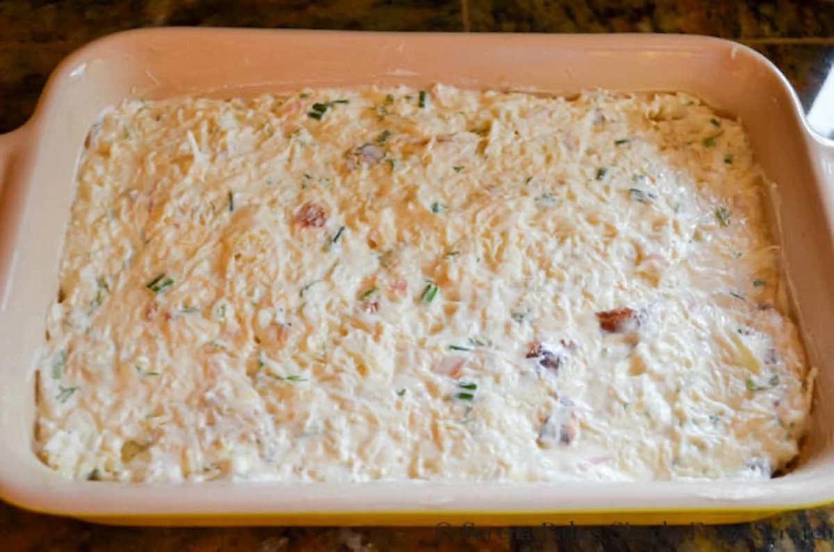 Dungness Crab Dip spread into a small pan.